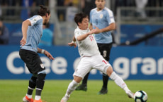 Soccer Football - Copa America Brazil 2019 - Group C - Uruguay v Japan - Arena Do Gremio, Porto Alegre, Brazil - June 20, 2019   Japan's Koji Miyoshi in action with Uruguay's Martin Caceres           REUTERS/Henry Romero